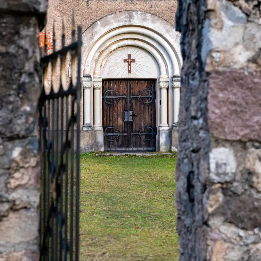 Open gate and door with cross